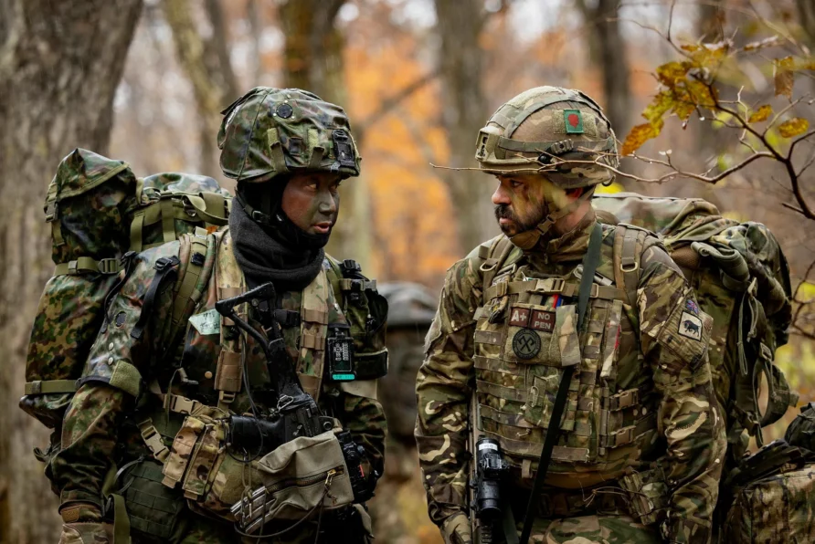 Soldier from 3rd Battalion Royal Regiment of Scotland speaks to a soldier from the 1st Airborne Brigade Japanese Ground Self Defence Force JGSDF - The Overburdened Infantry Soldier from 3rd Battalion Royal Regiment of Scotland speaks to a soldier from the 1st Airborne Brigade Japanese Ground Self Defence Force JGSDF - The Overburdened Infantry